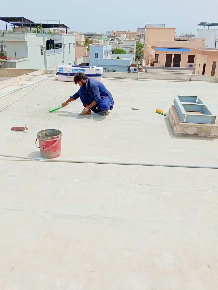 World Brothers Chemical Company team completing a rooftop waterproofing project in Karachi